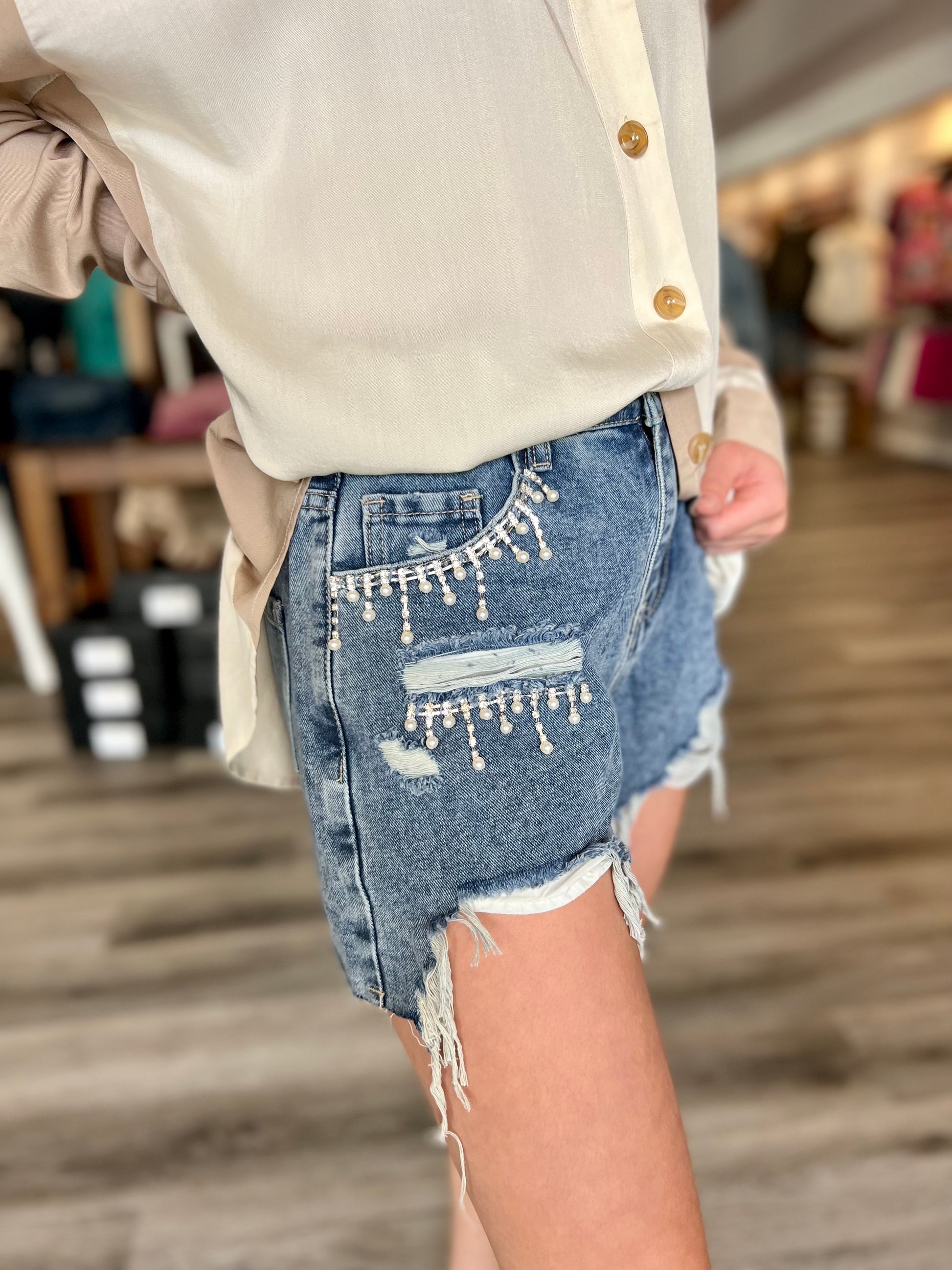 Shine bright in our dazzling rhinestone tassel denim shorts that bring the perfect mix of glam and edge to your summer wardrobe!  Trendy fashion, boutique, stylish women's clothing, chic apparel unique clothing store. fashion-forward
