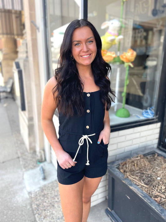 Step into effortless style with our black romper featuring chic khaki ties and button details!! Trendy fashion, boutique, stylish women's clothing, chic apparel unique clothing store. fashion-forward